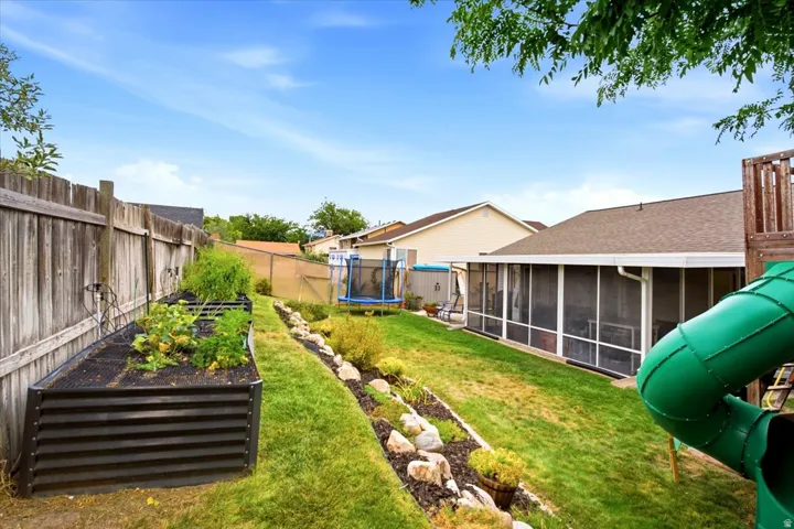 Screened-in porch, raised garden beds, wood privacy fence, gravel and rock landscaping, residential roofing