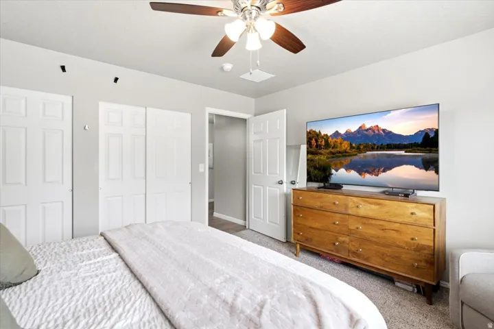 Ceiling fan with integrated lighting, paneled doors, and recessed lighting