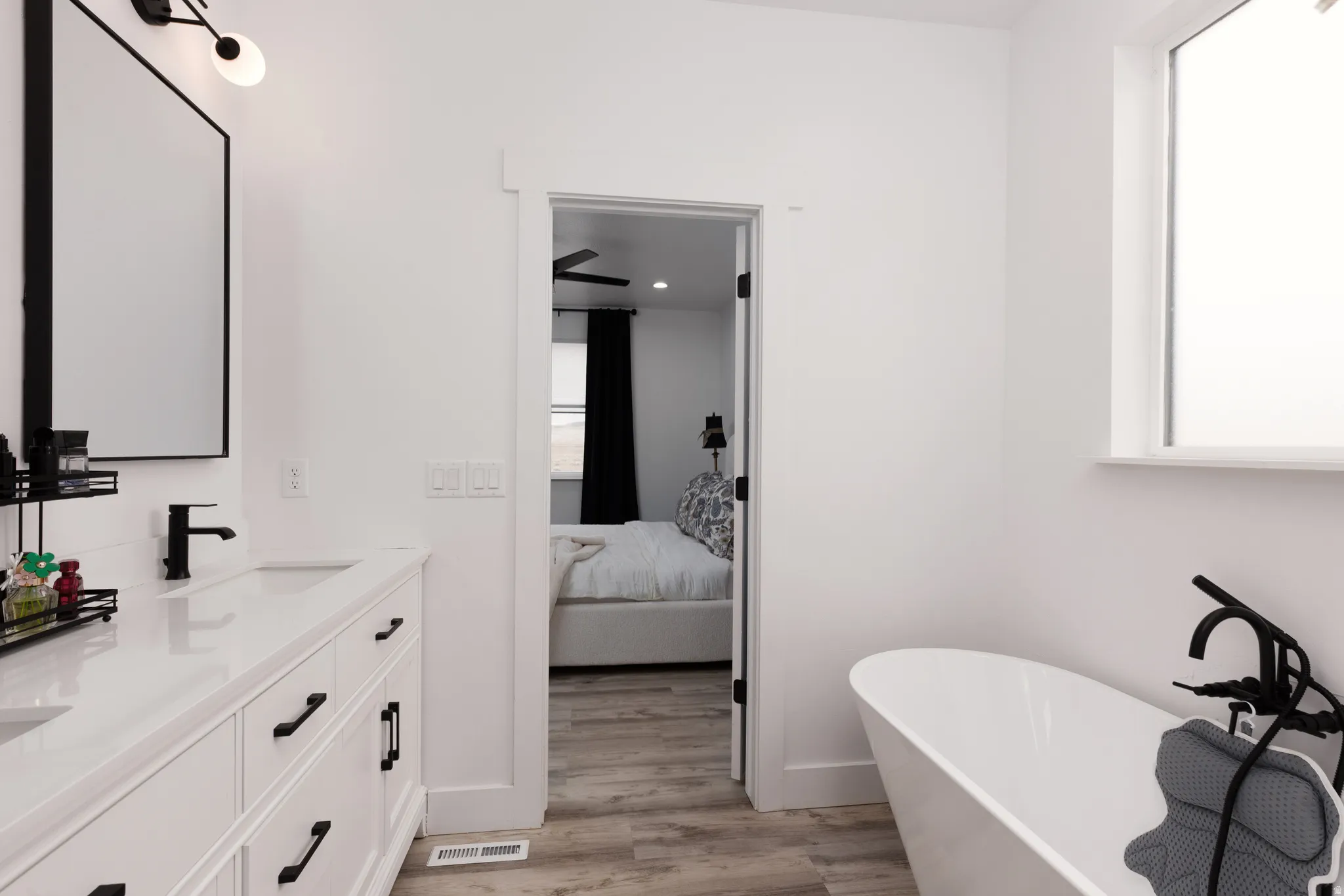 Dual sink vanity with white cabinetry and black hardware