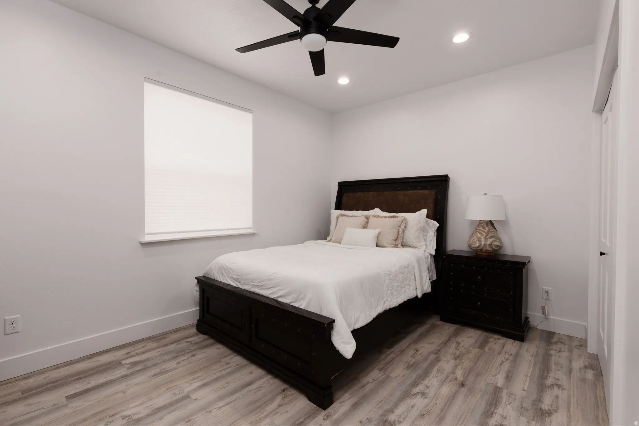 Wood-finish flooring, recessed lighting, and a ceiling fan with integrated lighting