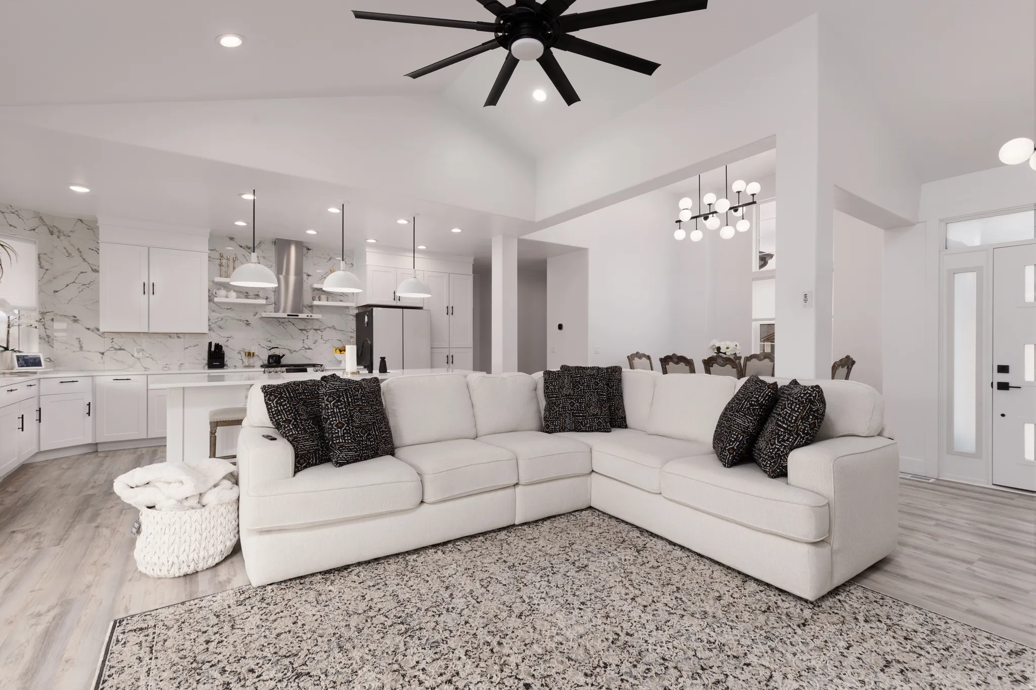 Vaulted ceilings and recessed lighting create a bright living space