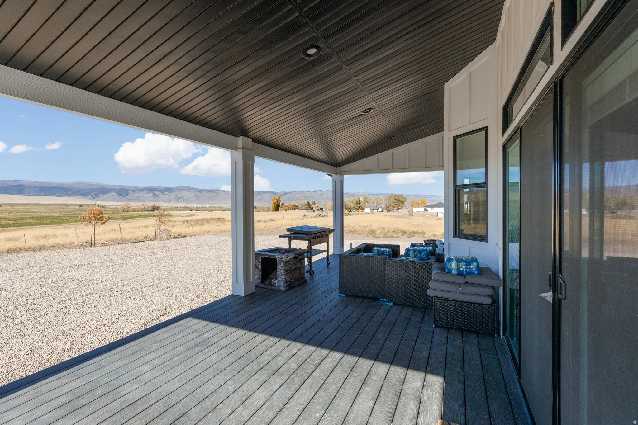 Covered outdoor patio with a dark wood-finish deck