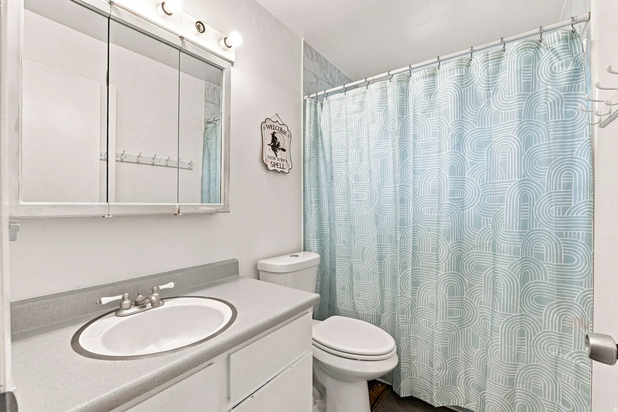 Vanity with an integrated sink and brushed nickel faucet