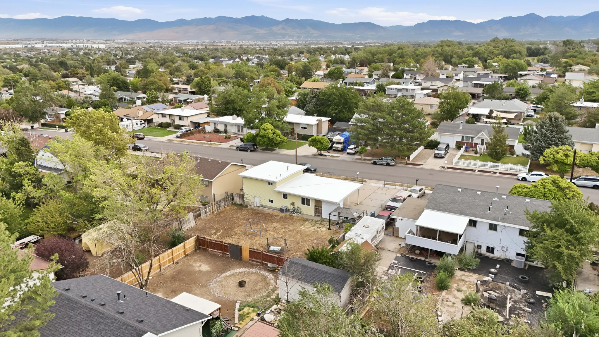 Aerial perspective showcasing residential properties within a developed neighborhood, featuring a distant mountain range