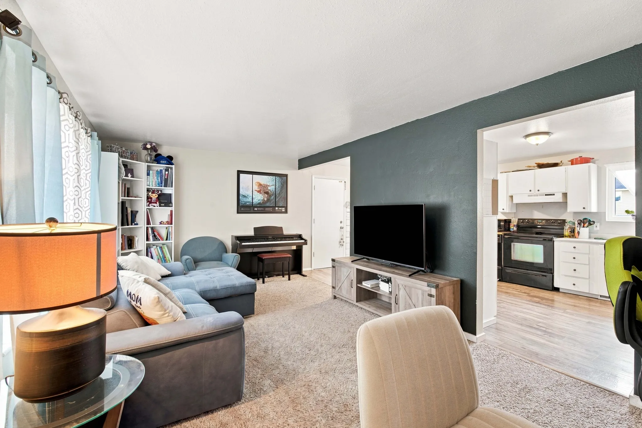 Broadloom carpeting paired with a wood-finish media console