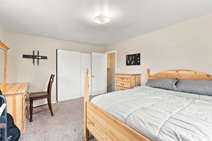 Neutral tone wall paint, textured ceiling, flush mount ceiling light fixture, and carpet flooring