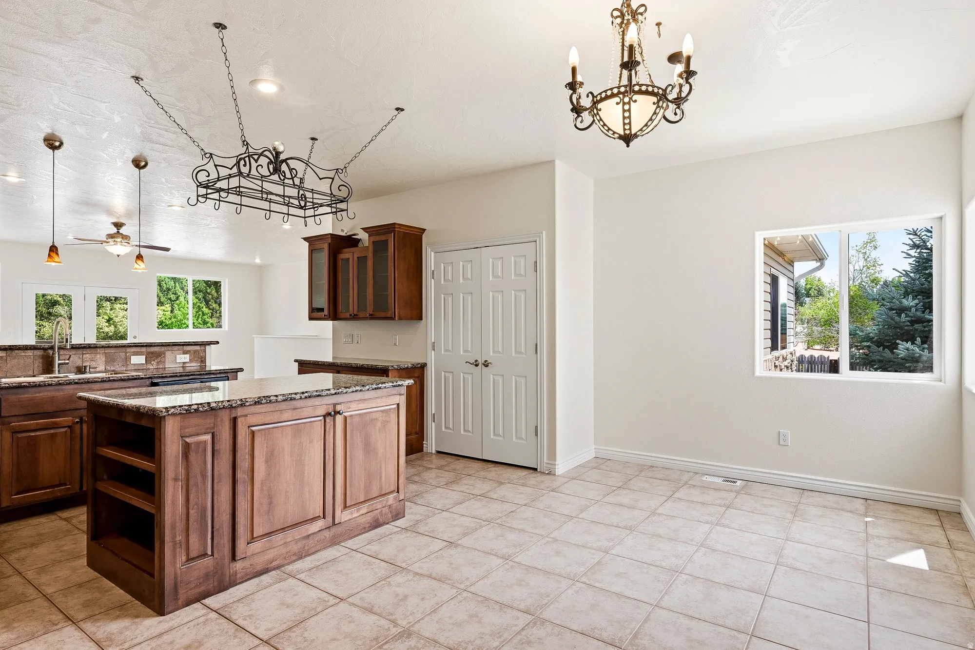 Kitchen featuring a central island with wood cabinetry, tile flooring, and integrated ceiling lighting