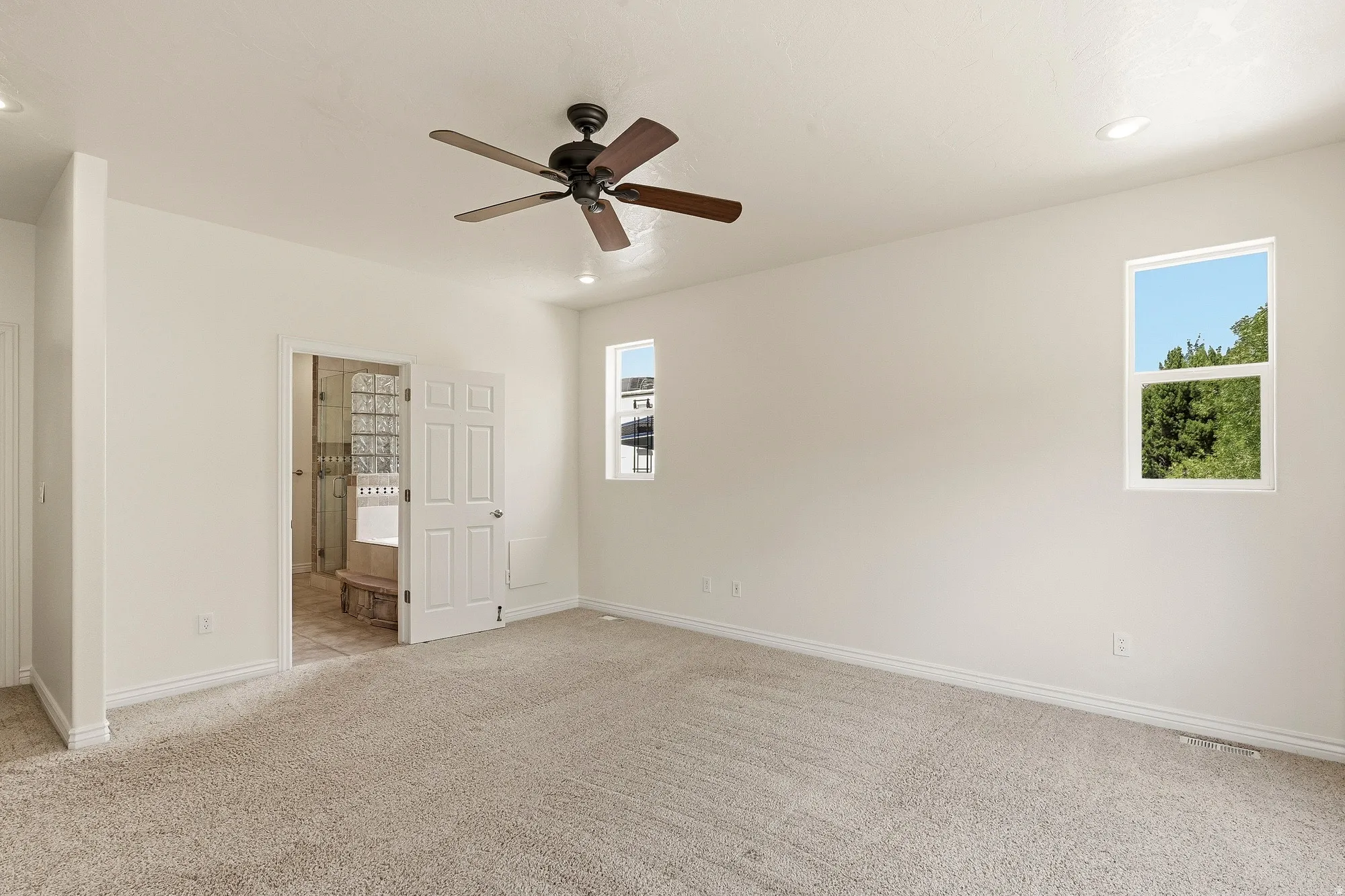Recessed lighting and a ceiling fan provide illumination