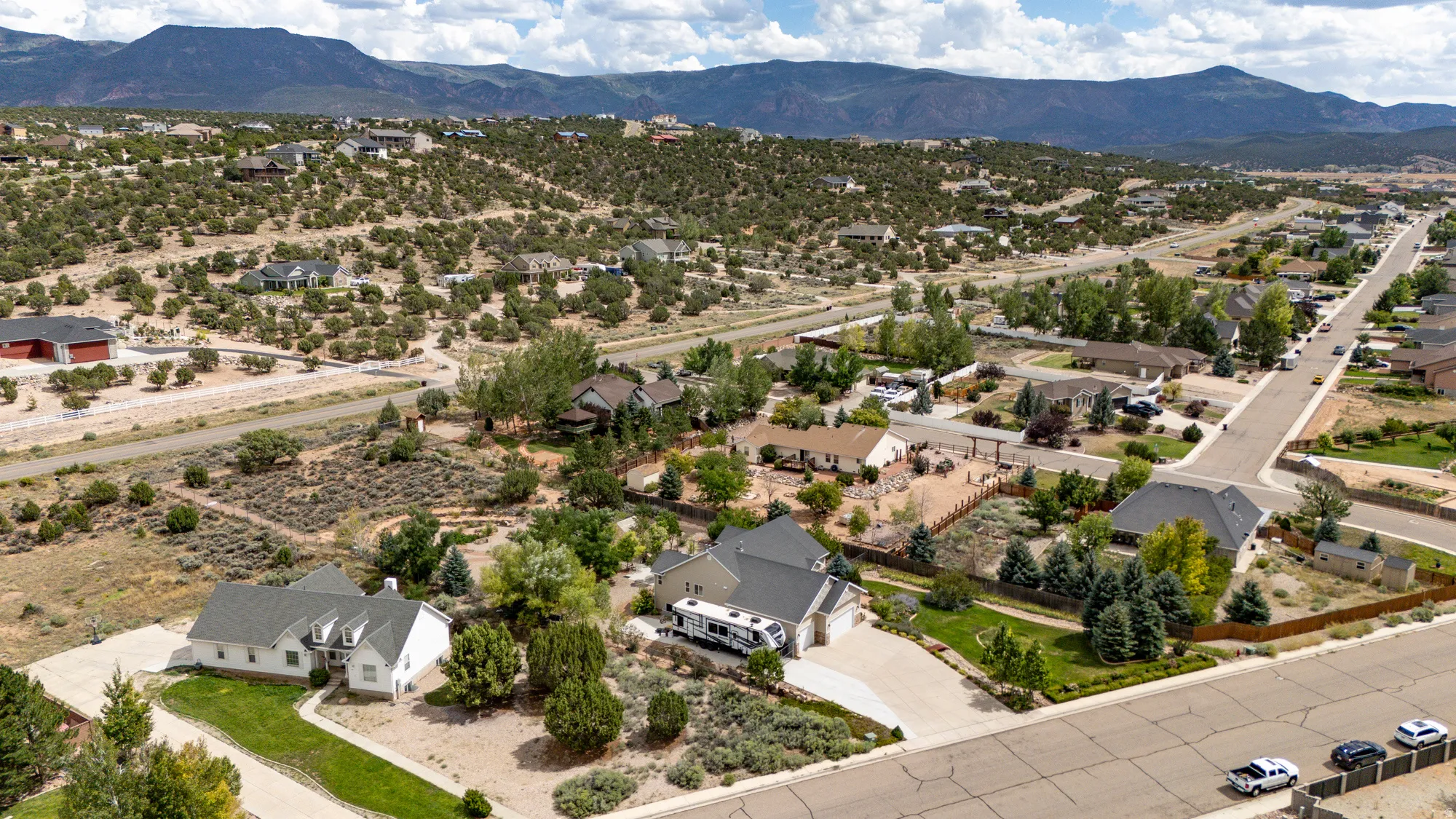 Expansive residential area featuring established homes, paved streets, and varied terrain with natural landscaping