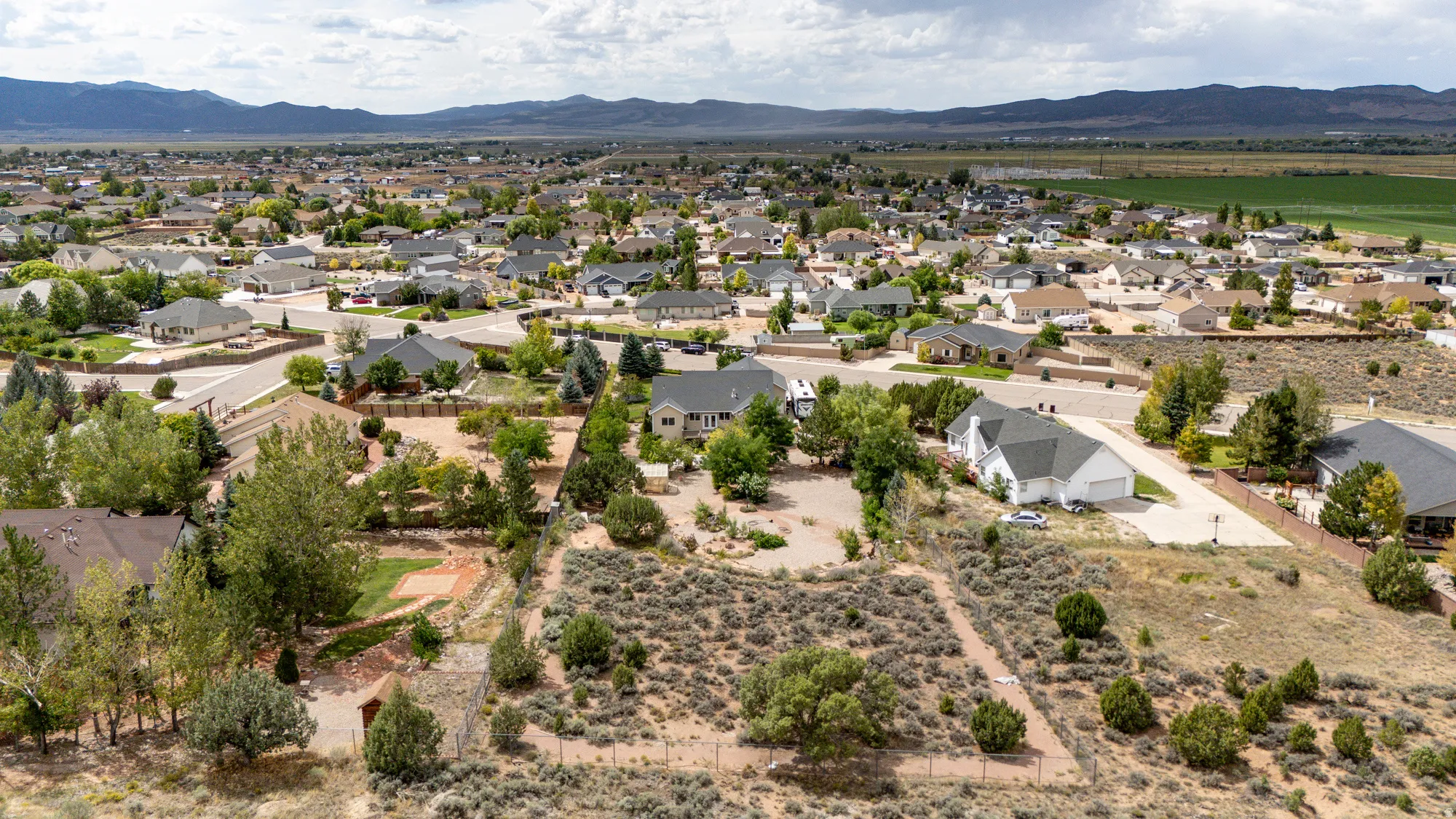 Aerial perspective showcasing a residential neighborhood with distant mountain ranges