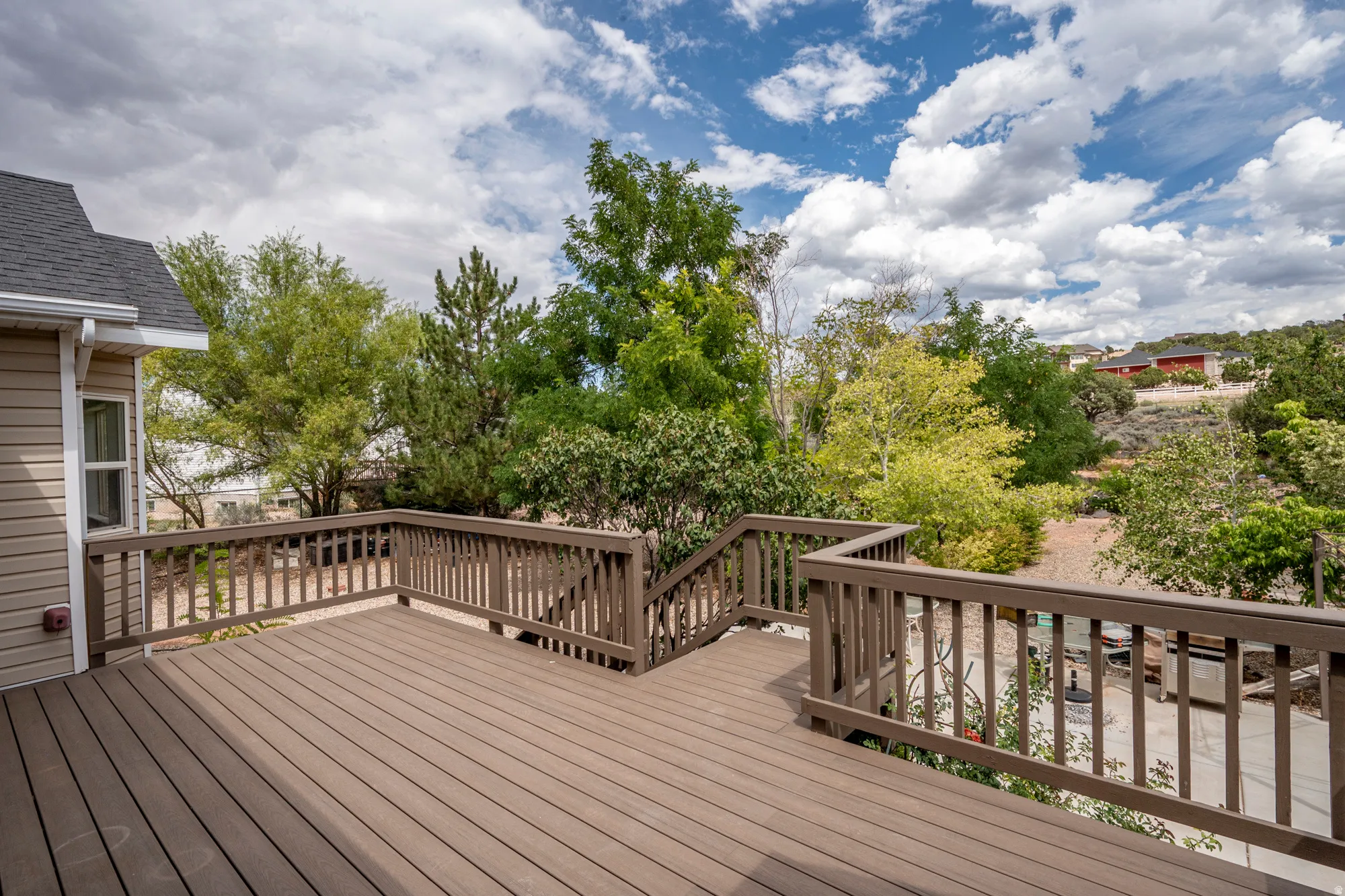 Expansive composite decking with railings, offering an elevated outdoor living space