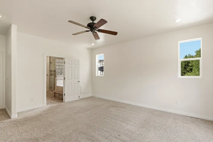 Recessed lighting and a ceiling fan provide illumination