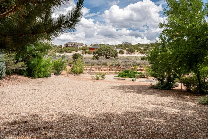 Terraced landscaping with established trees and shrubs