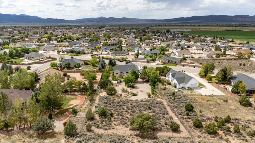 Aerial perspective showcasing a residential neighborhood with distant mountain ranges