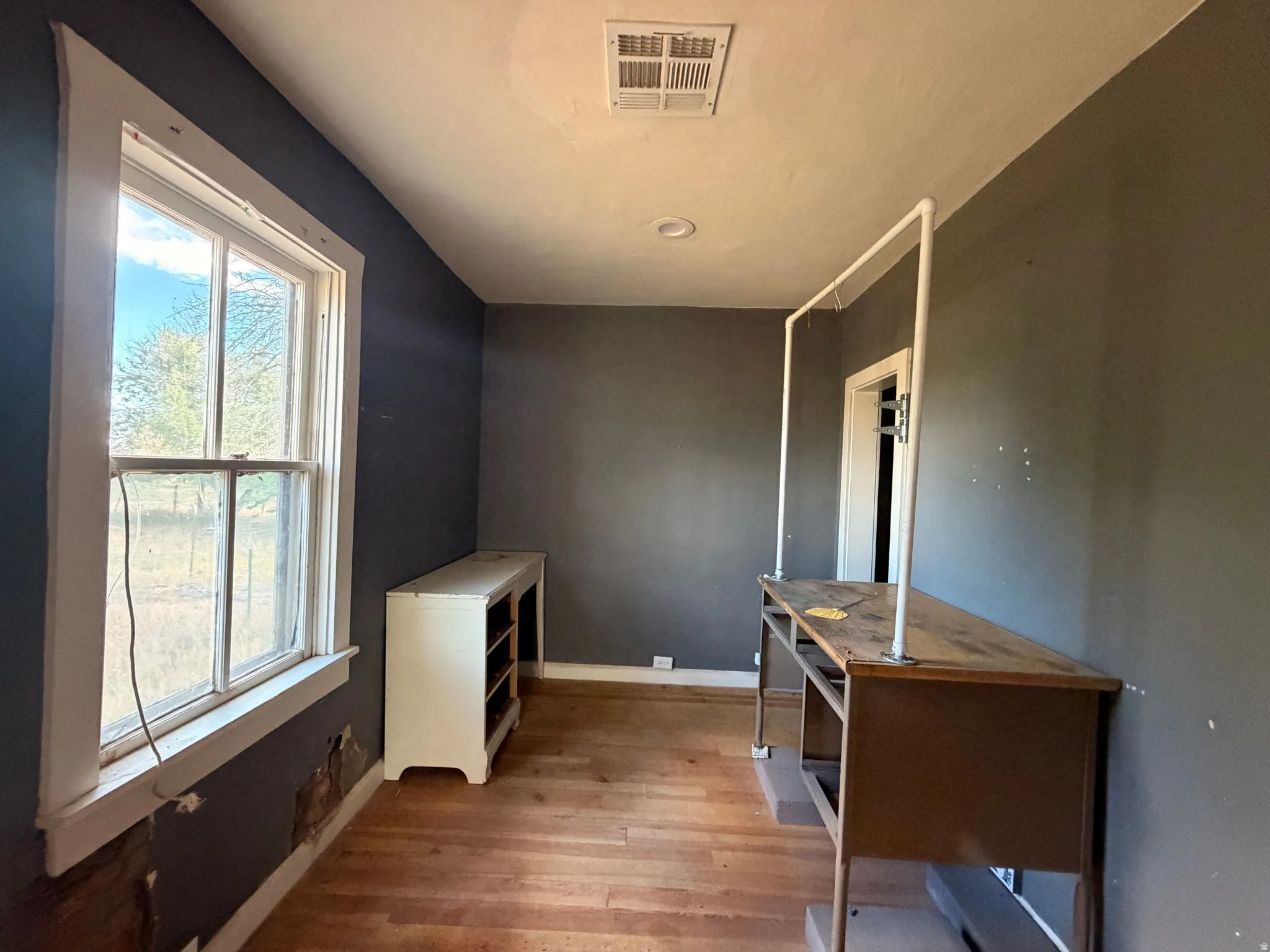 Wood-finish flooring with dark wall paint