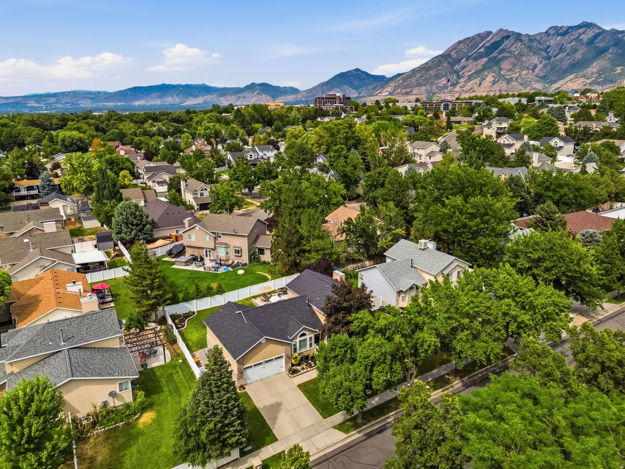 Mountainous backdrop framing a residential neighborhood with mature trees