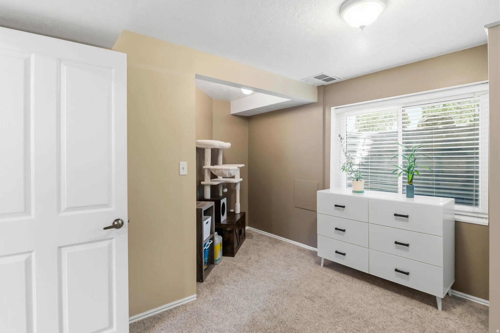 Recessed lighting and ceiling-mounted light fixture illuminate the space