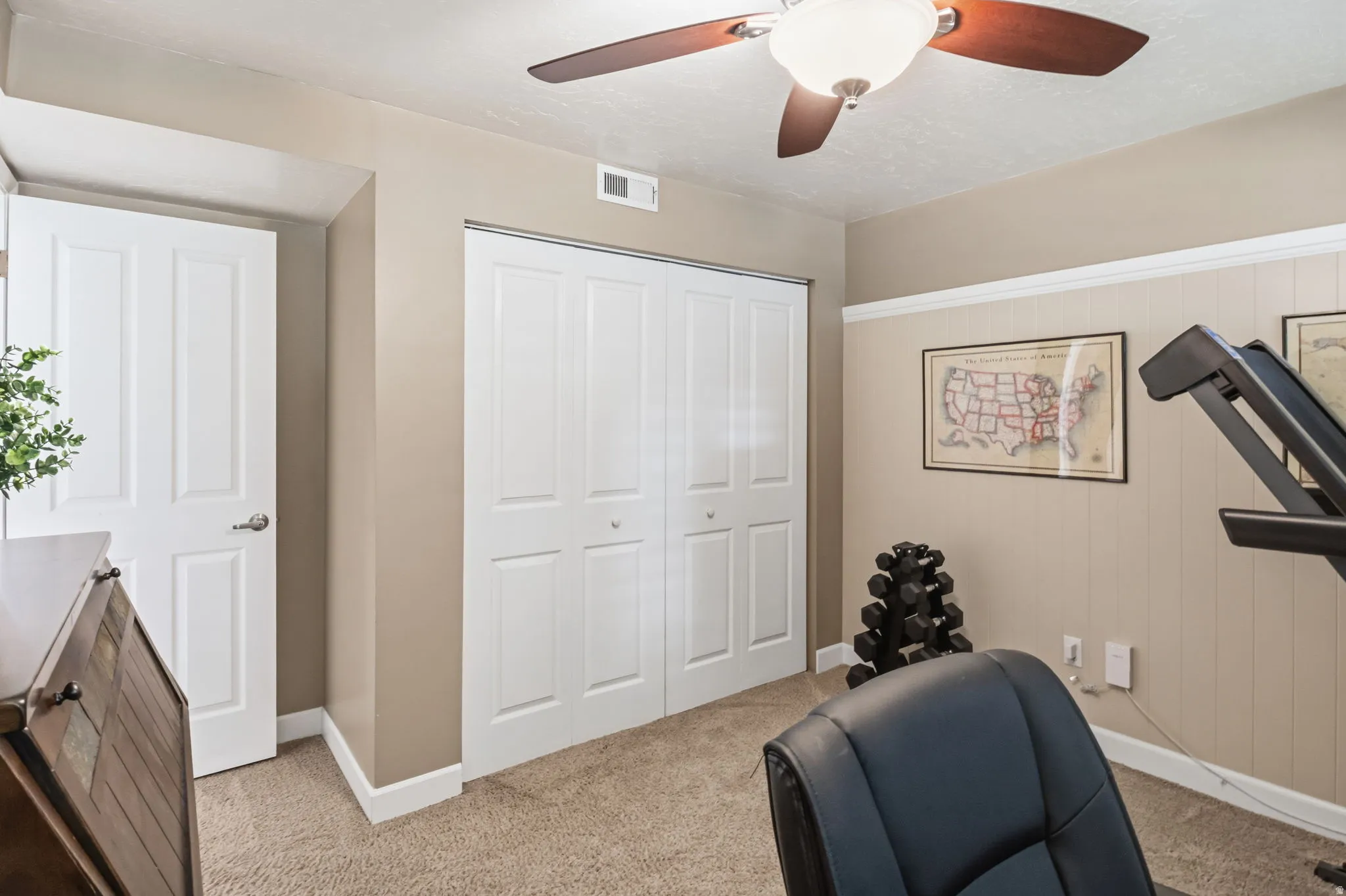 Carpeted flooring, bi-fold closet doors, ceiling fan with integrated lighting, and neutral wall tones