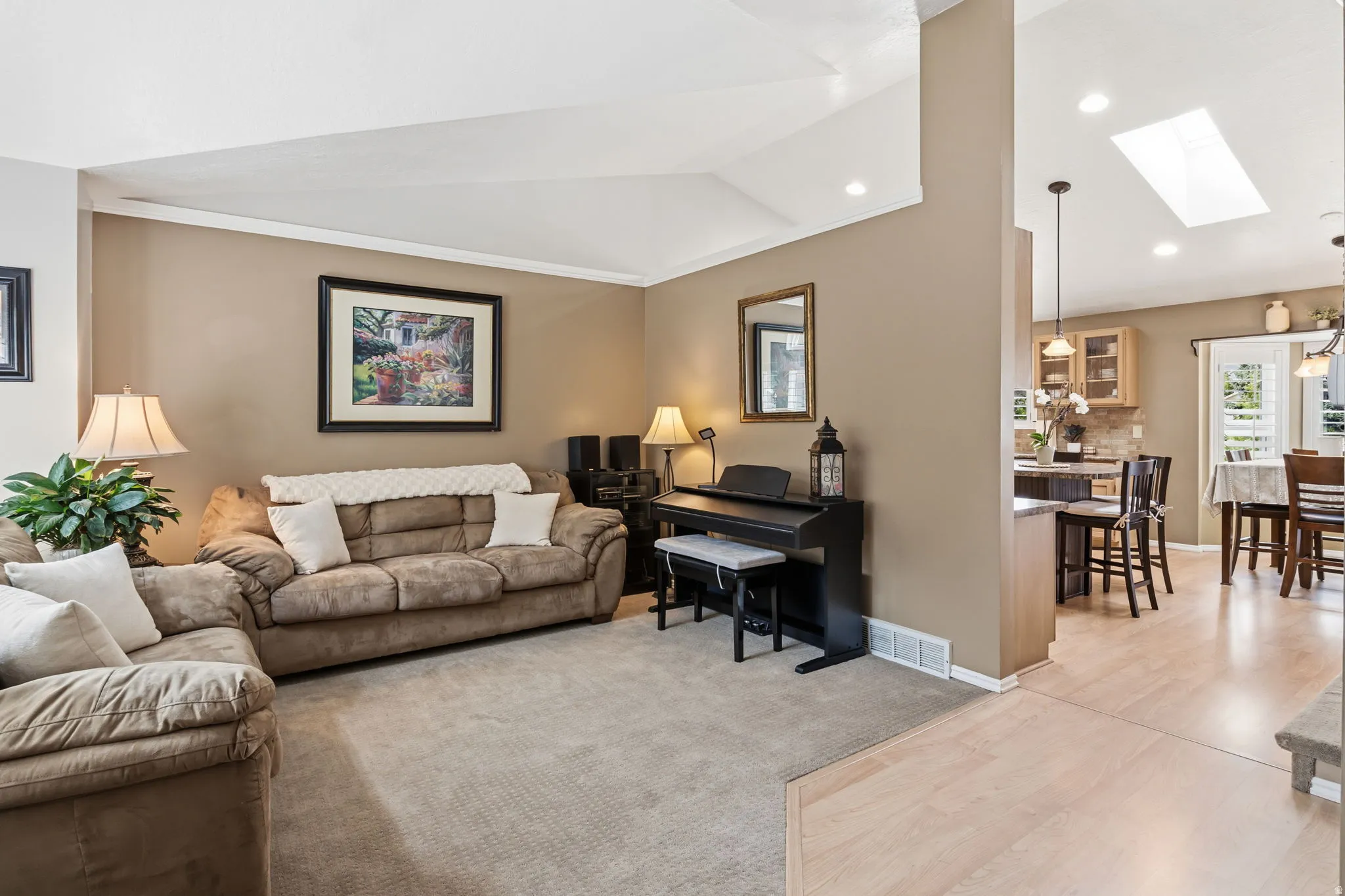 Vaulted ceiling, recessed lighting, skylight, light wood-finish flooring, built-in cabinetry