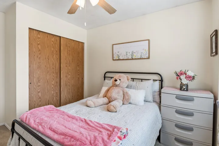 Ceiling fan, sliding wood-finish closet doors, light-toned wall paint