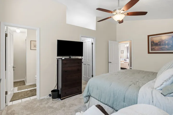 Vaulted ceilings, ceiling fan with integrated lighting, and neutral wall paint