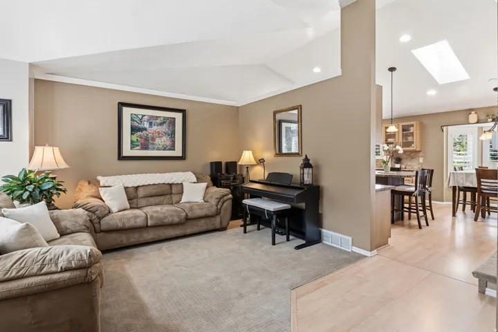 Vaulted ceiling, recessed lighting, skylight, light wood-finish flooring, built-in cabinetry