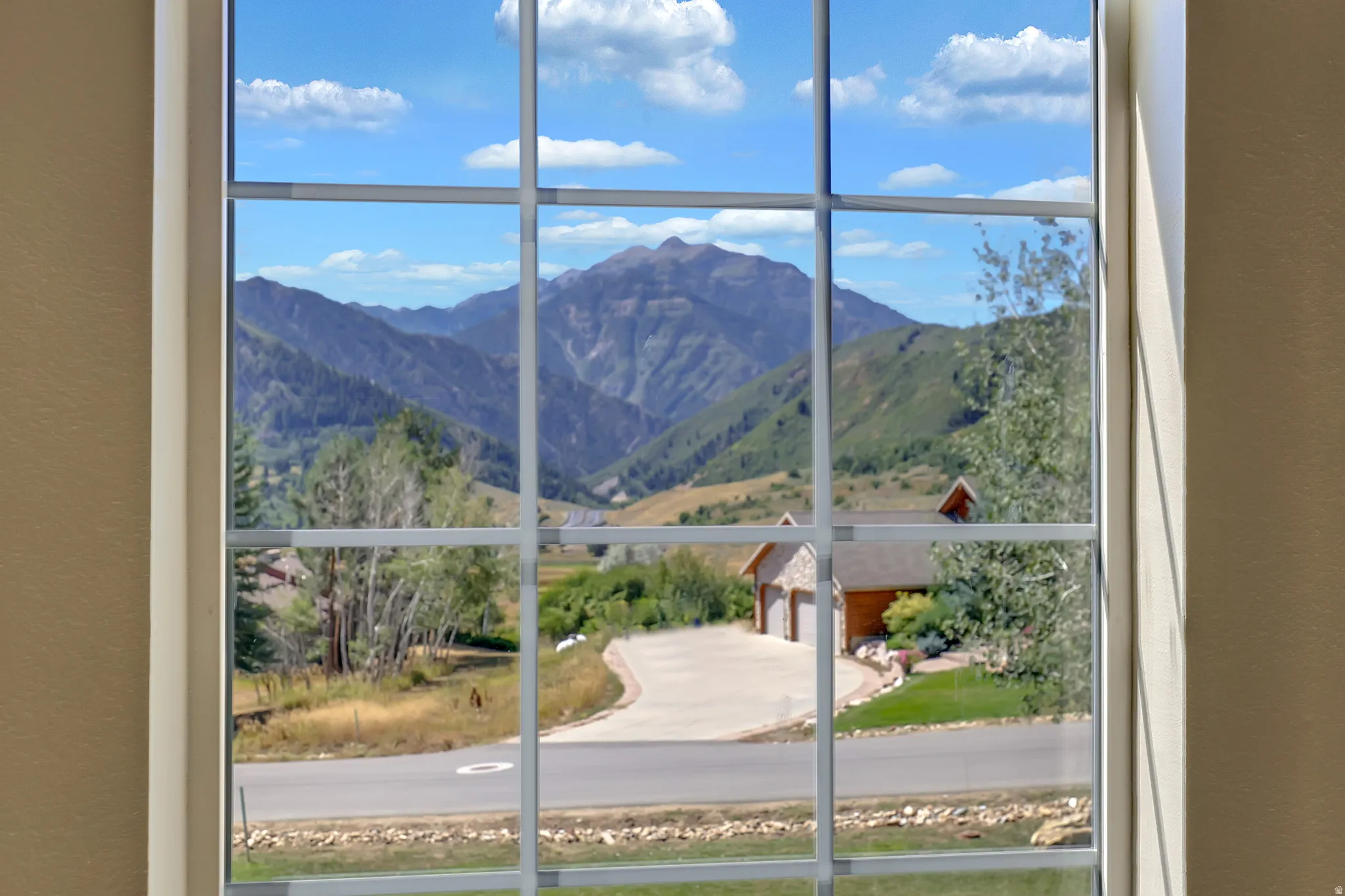 Window with muntins framing a mountain landscape