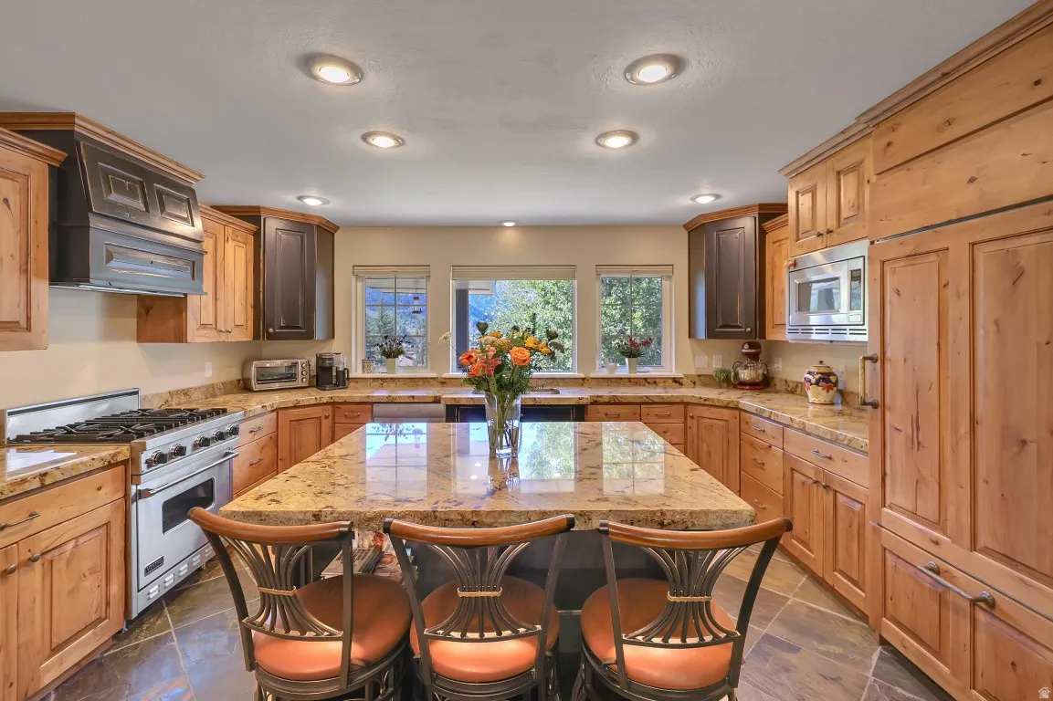 Gourmet kitchen with Viking range, Sub Zero refrigerator, granite countertops and mountain views