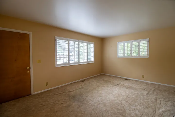 Dual windows featuring white plantation shutters