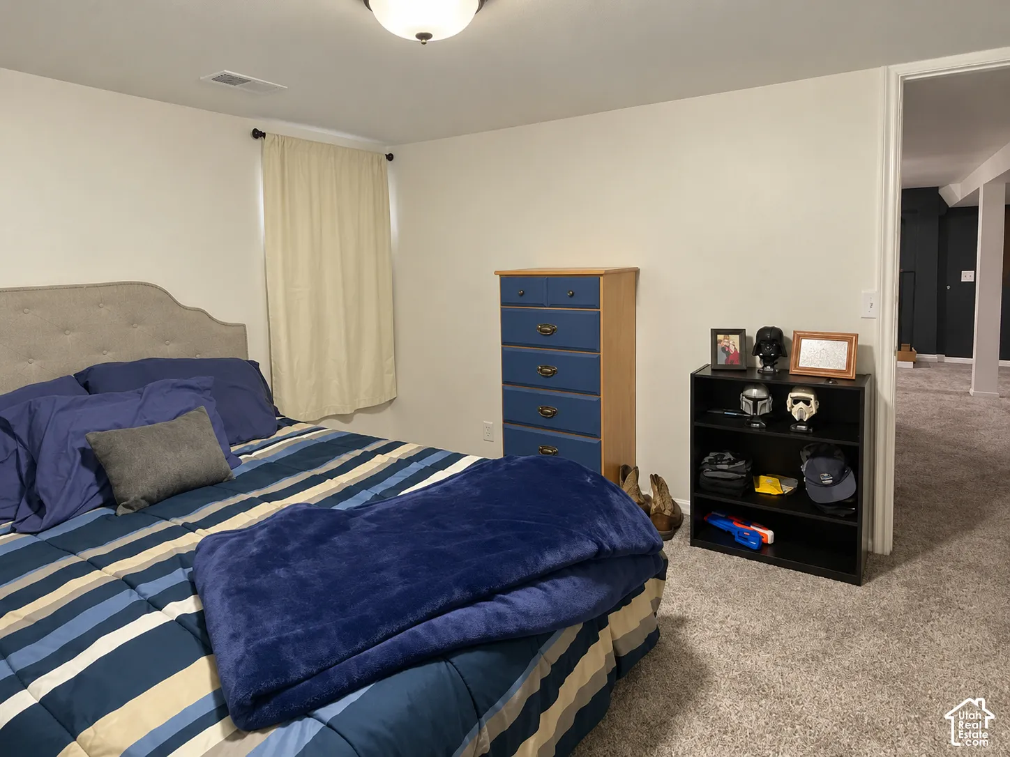 Neutral-toned wall paint, wall-to-wall carpeting, and flush-mount ceiling lighting