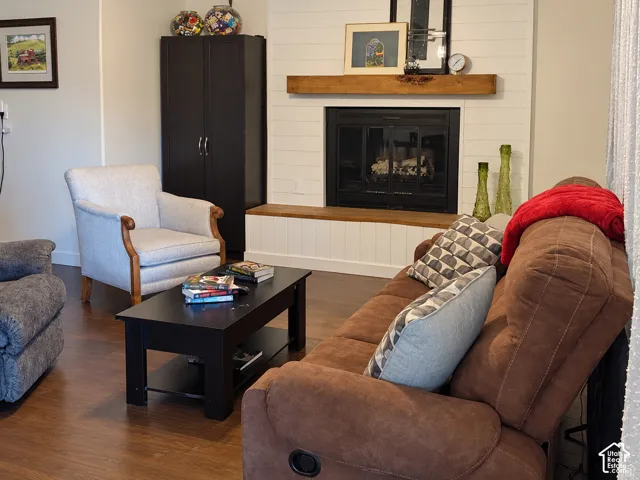 Fireplace featuring a white shiplap surround, wood-finish mantel, and built-in bench seating with wood-finish top