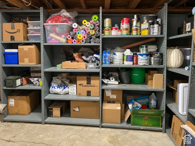 Industrial-style steel shelving units featuring adjustable metal brackets and a concrete floor