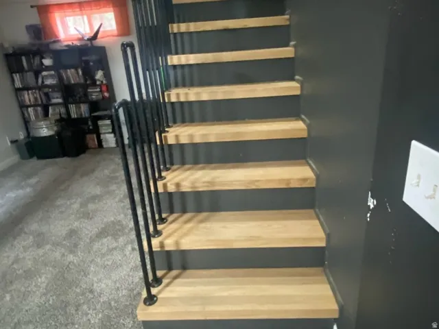 Custom staircase featuring wood-finish treads and black risers