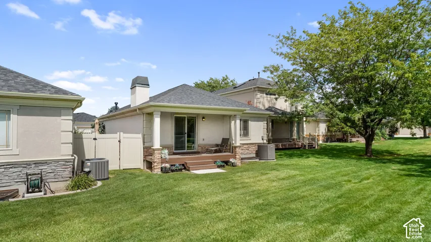 Expansive green lawn with a large mature tree