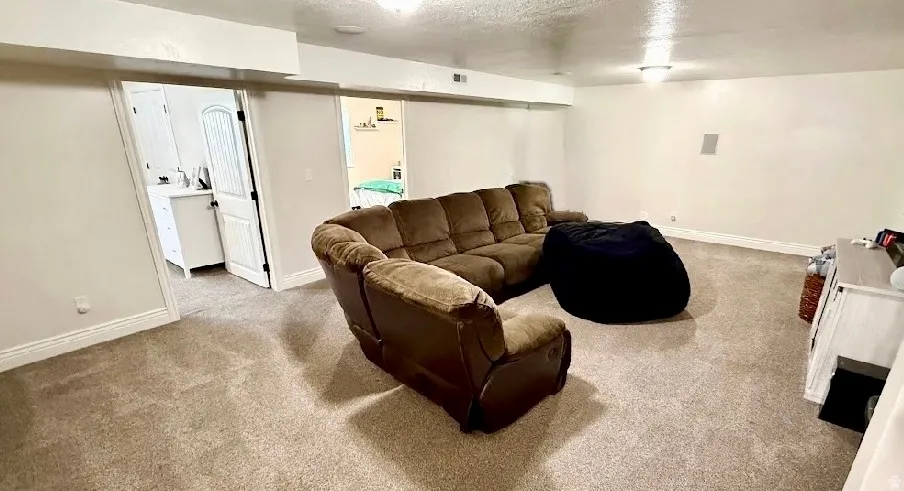 Carpeted room with recessed lighting and neutral wall tones