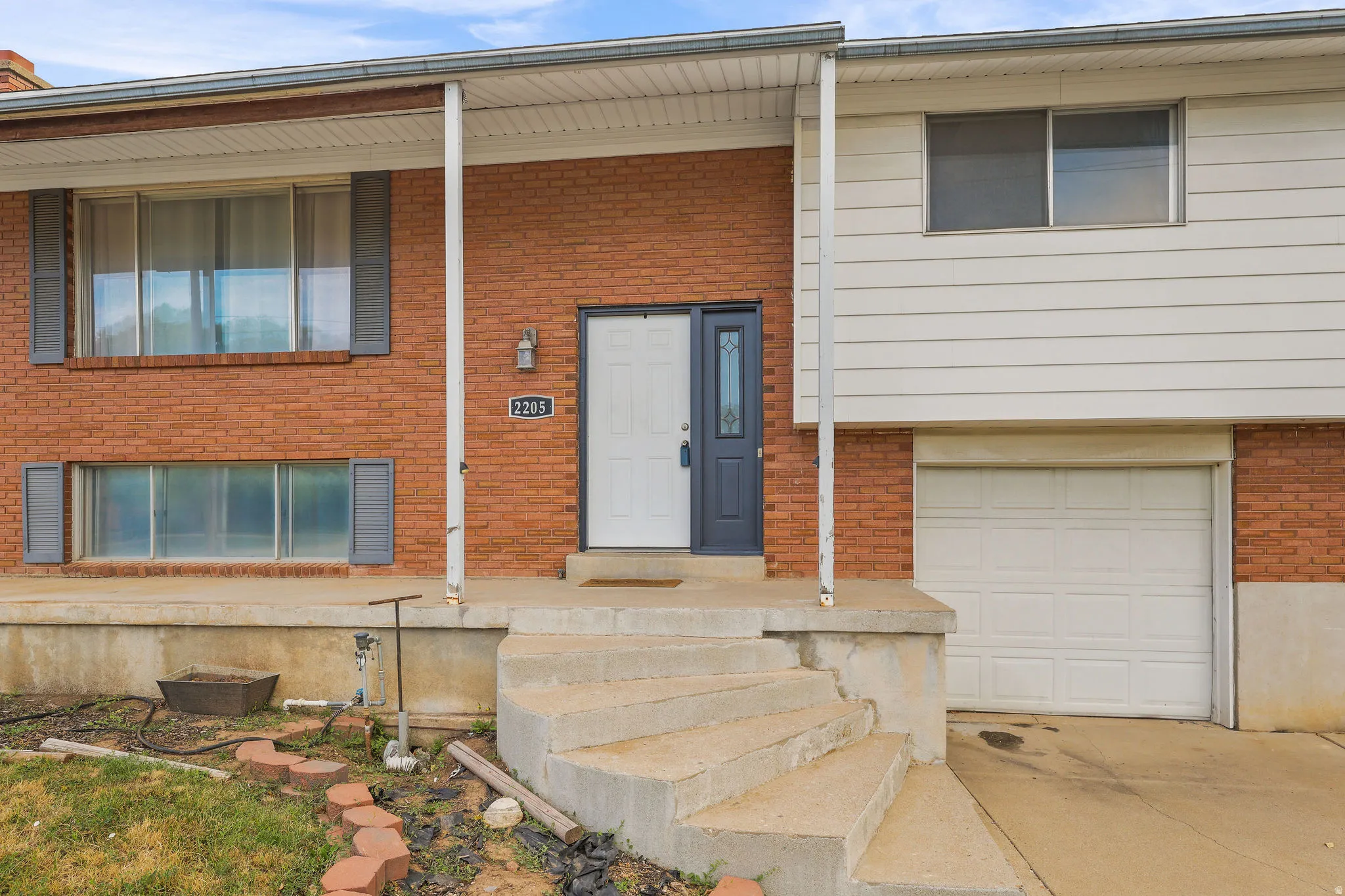 Brick facade with white siding accents