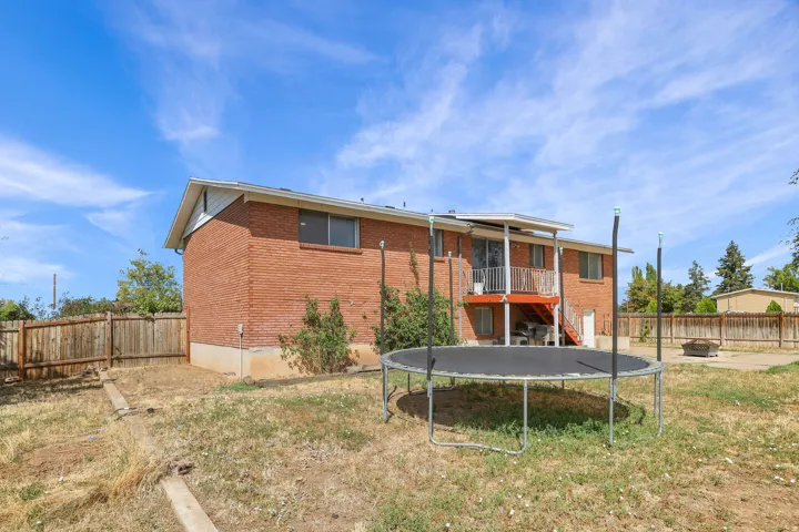Red brick exterior with white trim, featuring a covered balcony