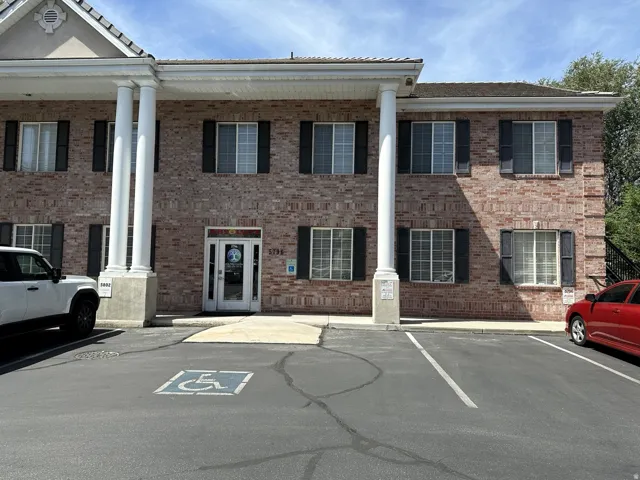 Brick exterior building with prominent white columns and a portico entrance