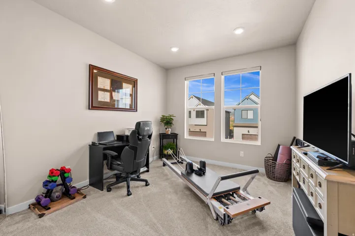Recessed lighting, light-toned walls, and carpet flooring