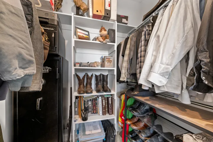 Built-in shelving with hanging rods and integrated shoe storage