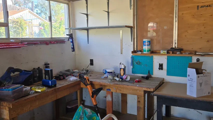 Built-in workbench, wall-mounted shelving, and pegboard storage