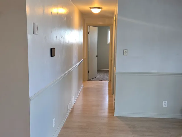 Wood-finish flooring throughout the hallway, Smart Thermostat