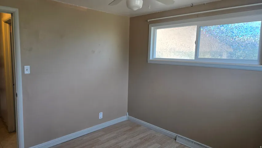 Bedroom # 2 Neutral-toned walls with light wood-finish flooring