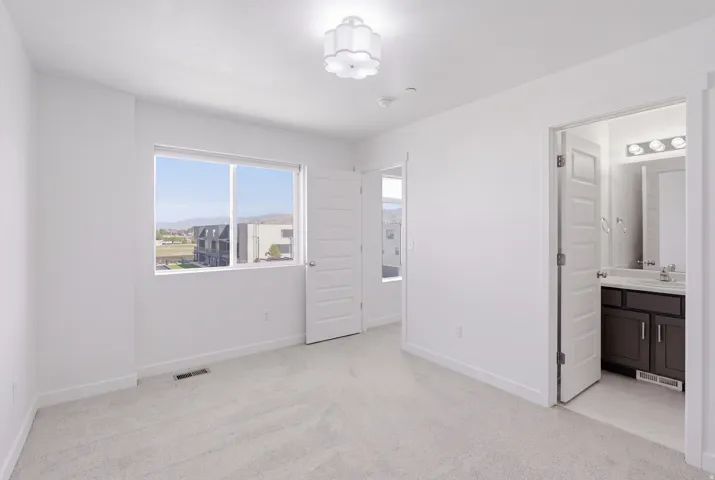 Neutral-toned wall-to-wall carpeting and white walls
