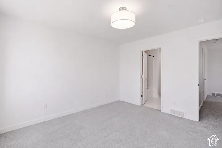 Recessed lighting, light gray carpet flooring, and a contemporary ceiling fixture
