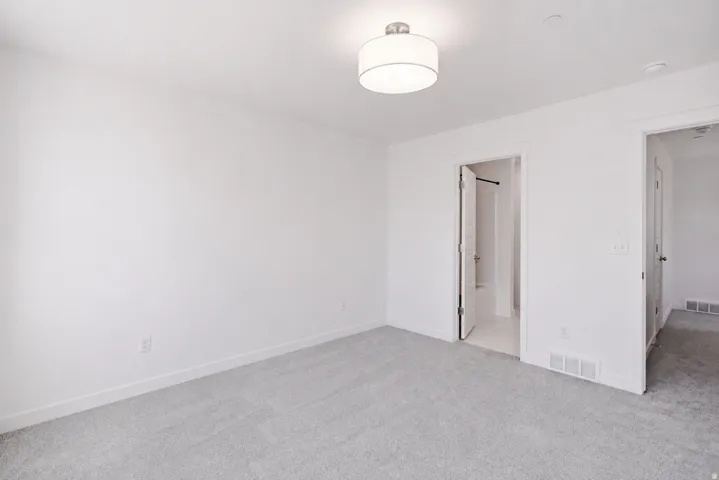 Recessed lighting, light gray carpet flooring, and a contemporary ceiling fixture