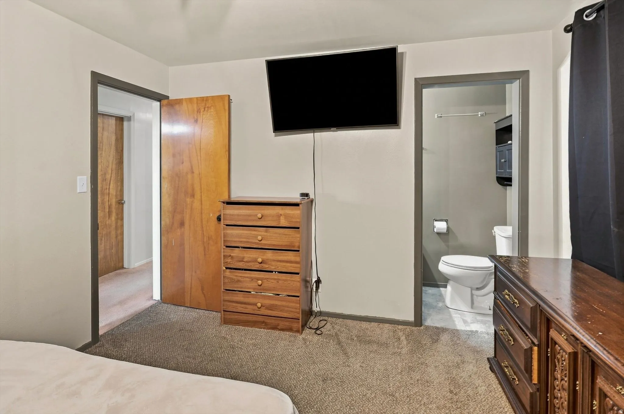 Carpeted flooring, light neutral wall paint with a half master bathroom