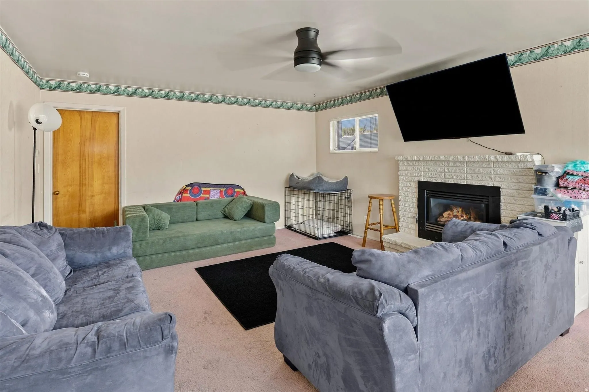 Very large living room with fireplace and door that closes if off to the hallway