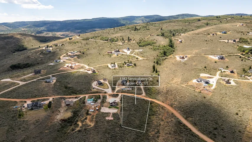 Expansive lot with demarcated boundaries, surrounded by natural terrain