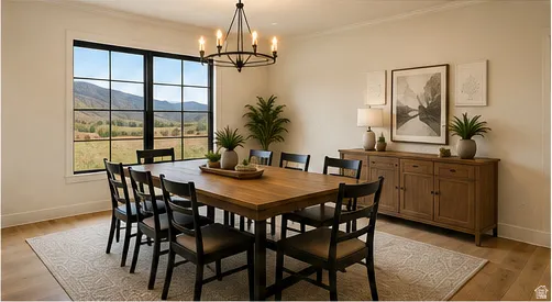 Spacious dining area featuring a prominent window, wood-finish flooring, a built-in chandelier, and a built-in wooden sideboard
